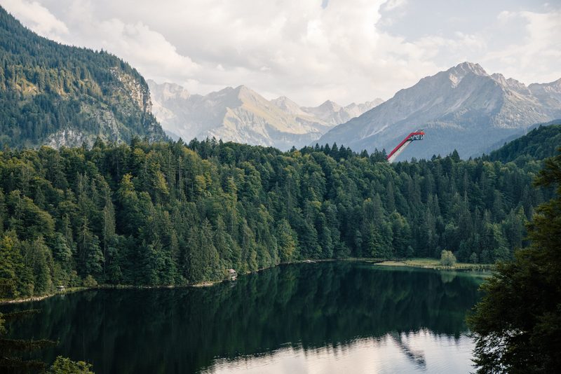 View across the Freibergsee near Oberstdorf to the Heini-Klopfer ski-flying hill, Allgäu peaks behind